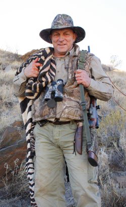 Victor carrying his Zebraskin after it was slaughtered on the mountain Hartmann's Zebra Hunt Namibia